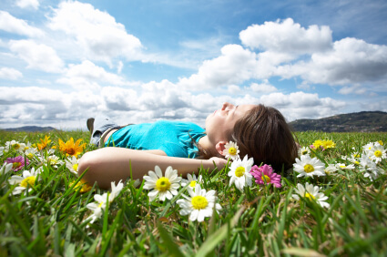 Woman lying in a field of flowers