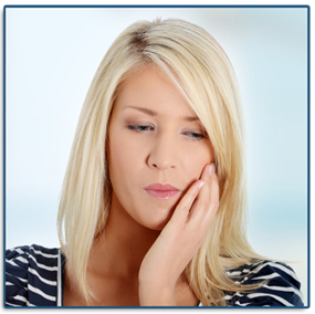Woman holding her cheek needing a tooth extraction. 