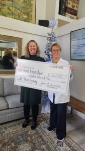 4th quarter giveaway winner holding a large check.